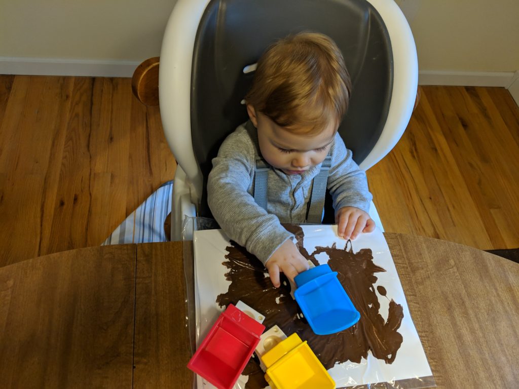 This construction themed activity shows Little Man painting with trucks. 