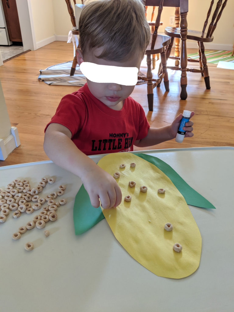 Little Man creating his corn cob.