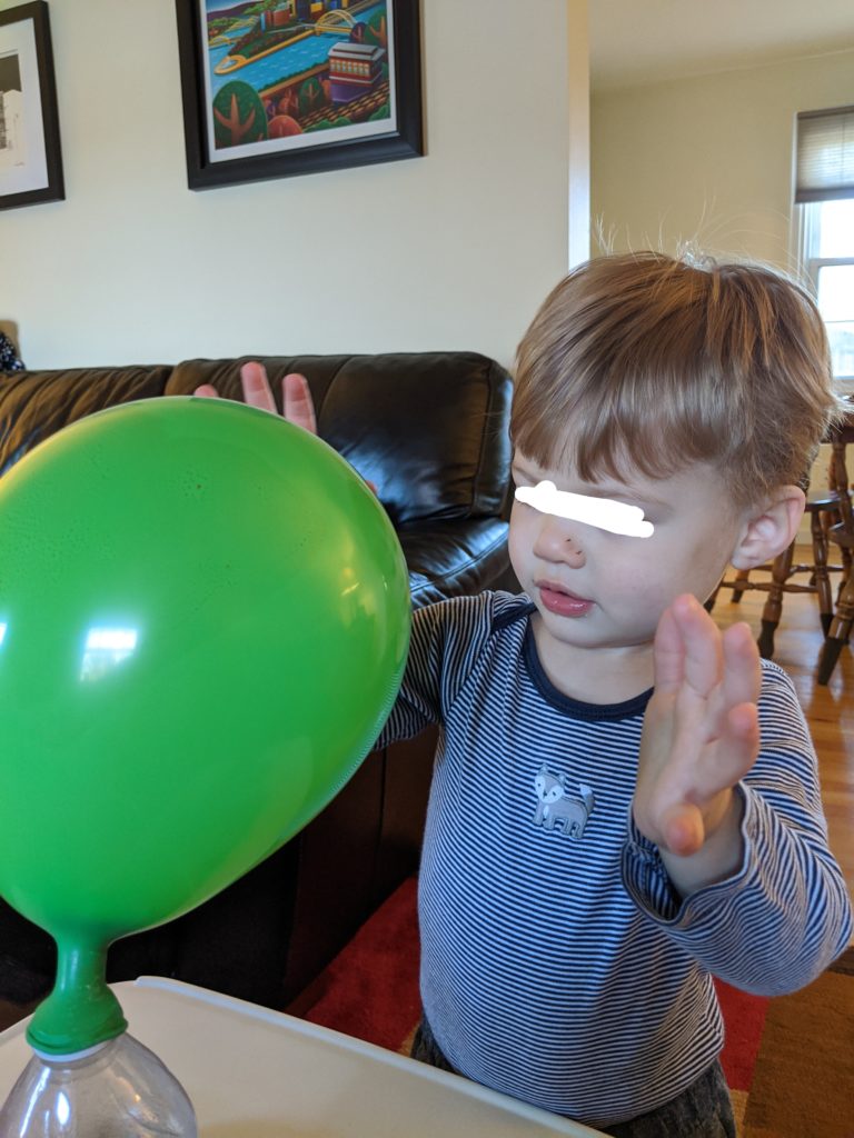 Little Man watching the balloon grow!